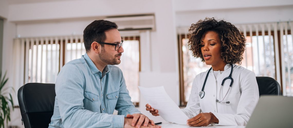 Doctor talking to a patient at medical clinic.