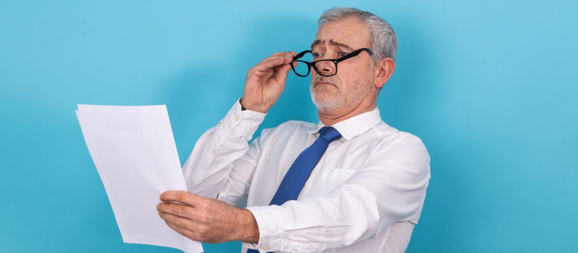 business man looking with glasses with presbyopia isolated